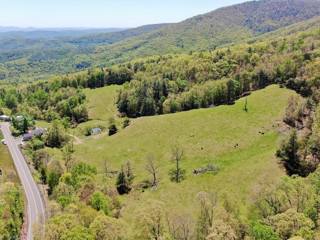 bird's eye view with a mountain view and a wooded view