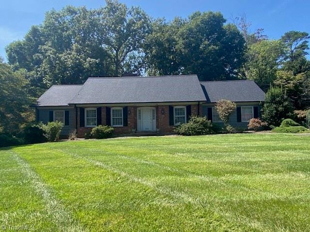 single story home featuring a front lawn