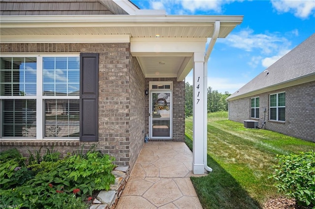 1417 Blooming Mountain Way, Kernersville, NC 27284 - entrance to property with a lawn, central air condition unit, and brick siding