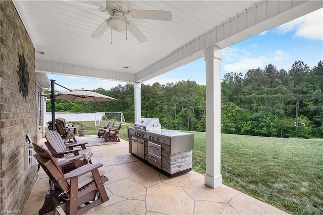 1417 Blooming Mountain Way, Kernersville, NC 27284 - view of patio / terrace with grilling area, a forest view, a ceiling fan, an outdoor kitchen, and outdoor dining space