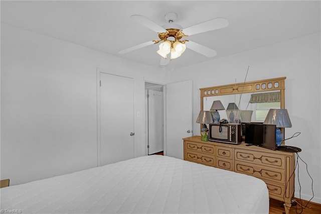 bedroom with ceiling fan and hardwood / wood-style floors