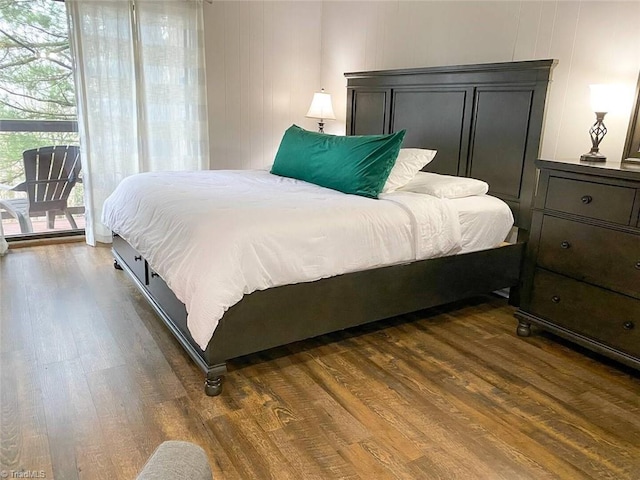 bedroom with dark wood finished floors