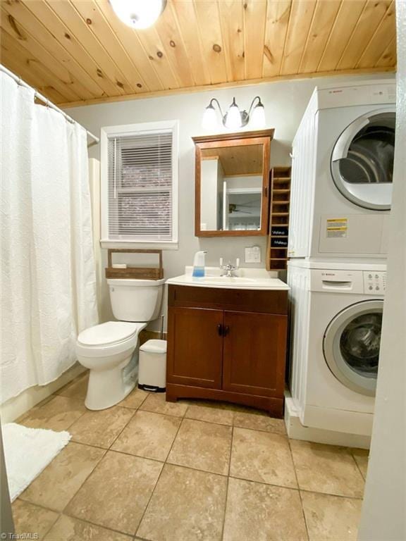bathroom with tile patterned floors, toilet, stacked washing maching and dryer, and wood ceiling