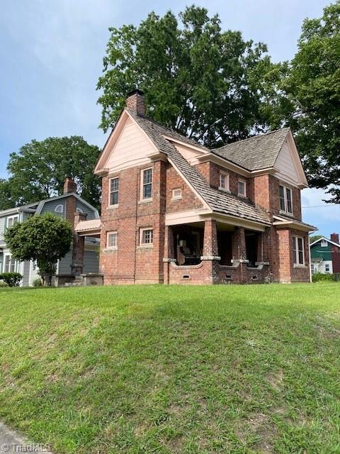 rear view of property with a yard