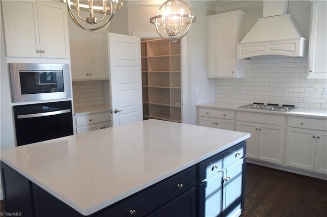 8113 Simon Dr Lot 38, Stokesdale, NC 27357 - kitchen with stainless steel appliances, a chandelier, premium range hood, light countertops, and white cabinetry