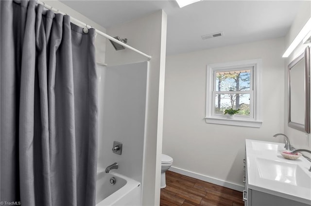2281 Quarter Rd, Swanquarter, NC 27885 - bathroom featuring wood finished floors, toilet, shower / bath combination with curtain, baseboards, and double vanity