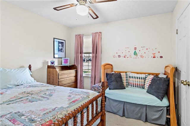 bedroom with light carpet and a ceiling fan