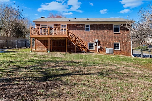 back of property featuring stairway, fence private yard, a lawn, and a deck