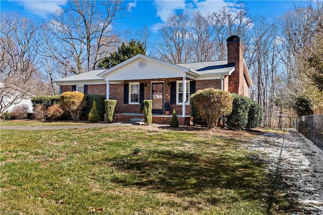 view of front of property with a chimney, fence, a front lawn, a porch, and brick siding