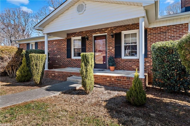 view of front facade with a porch and brick siding