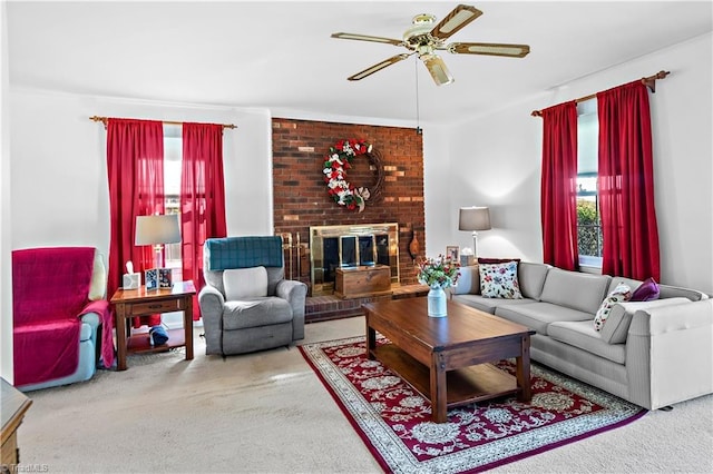 carpeted living area with a ceiling fan, a brick fireplace, and a healthy amount of sunlight