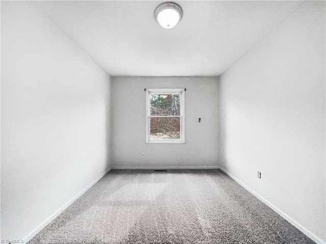 carpeted spare room with baseboards