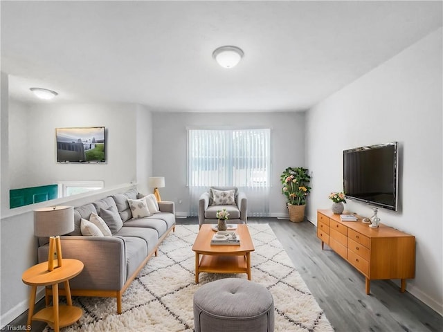 living room featuring light wood-style flooring and baseboards