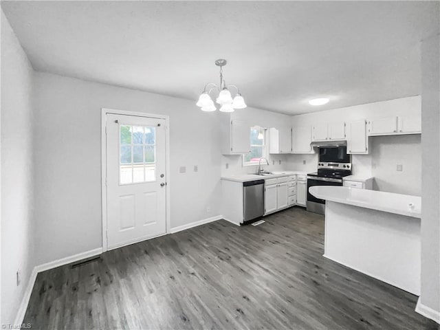 kitchen with dark wood-style floors, light countertops, appliances with stainless steel finishes, and white cabinetry