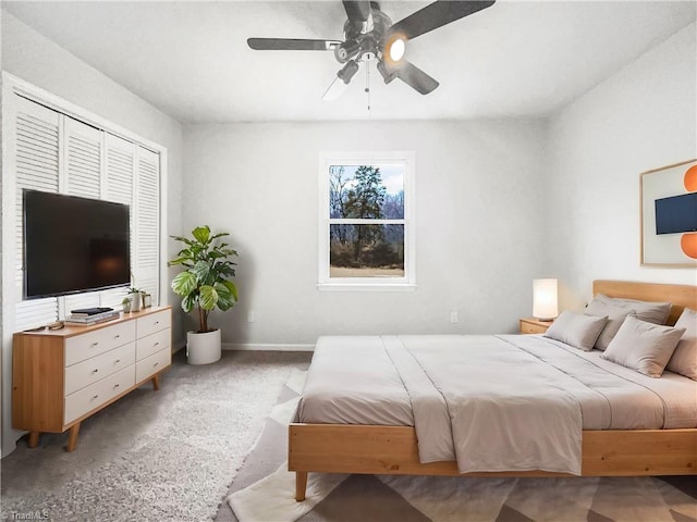 bedroom featuring ceiling fan, baseboards, and light colored carpet