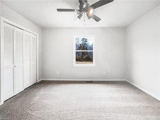 unfurnished bedroom with ceiling fan, a closet, and baseboards