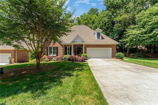 4002 Hobbs Rd, Greensboro, NC 27410 - view of front facade with brick siding, concrete driveway, a garage, and a front lawn