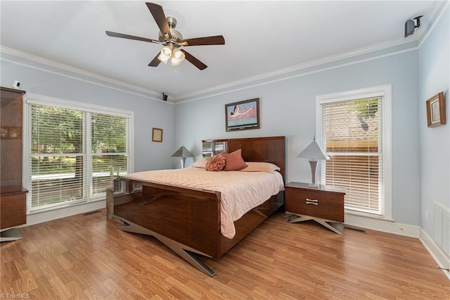 4002 Hobbs Rd, Greensboro, NC 27410 - bedroom with multiple windows, crown molding, light wood finished floors, and ceiling fan