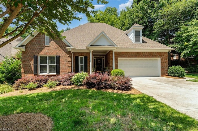 4002 Hobbs Rd, Greensboro, NC 27410 - view of front of house with brick siding, a garage, driveway, a front yard, and a shingled roof