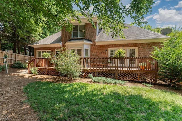 4002 Hobbs Rd, Greensboro, NC 27410 - back of house featuring a shingled roof, a wooden deck, and brick siding