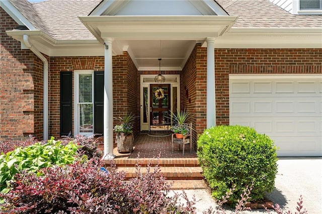 4002 Hobbs Rd, Greensboro, NC 27410 - property entrance featuring a shingled roof, brick siding, a garage, and a porch