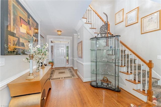 4002 Hobbs Rd, Greensboro, NC 27410 - entryway featuring stairway, wood finished floors, and crown molding