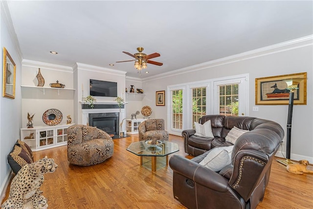 4002 Hobbs Rd, Greensboro, NC 27410 - living area with ceiling fan, wood finished floors, ornamental molding, a high end fireplace, and recessed lighting