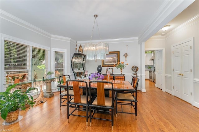 4002 Hobbs Rd, Greensboro, NC 27410 - dining area with light wood-type flooring, crown molding, and a chandelier