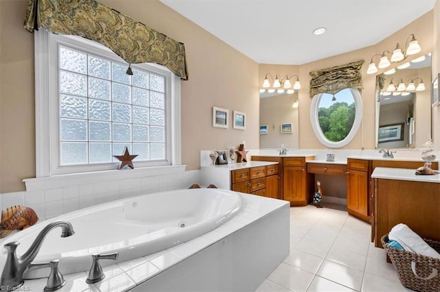 full bath with vanity, tile patterned flooring, and a jetted tub
