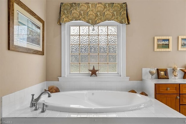 bathroom with a garden tub and a wealth of natural light