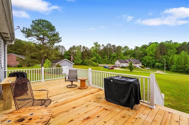 deck featuring a storage unit, an outdoor structure, and a yard