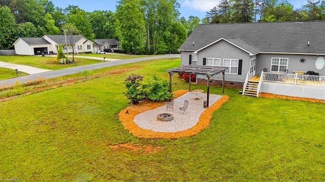 view of yard featuring a fire pit, a pergola, a patio, and a wooden deck