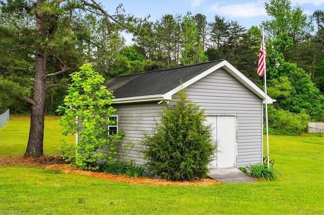 view of outbuilding featuring an outdoor structure and fence