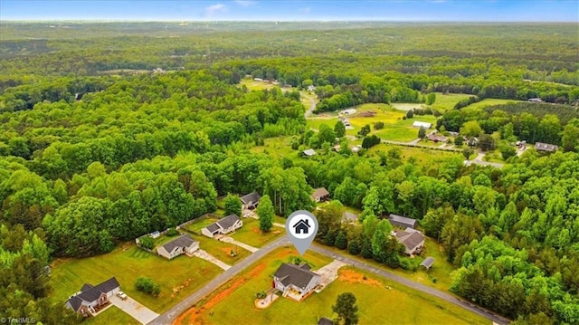 birds eye view of property featuring a view of trees