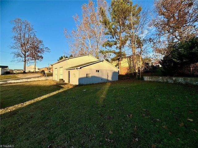 view of side of home with a yard