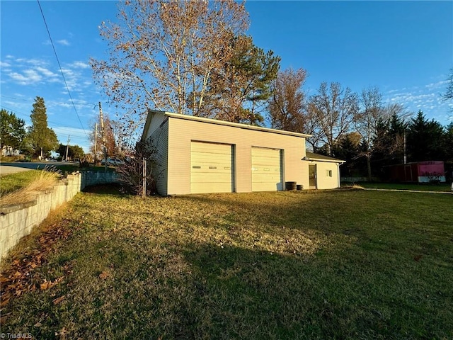 garage featuring a lawn