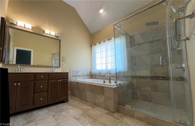 bathroom featuring lofted ceiling, double vanity, a stall shower, a bath, and a sink