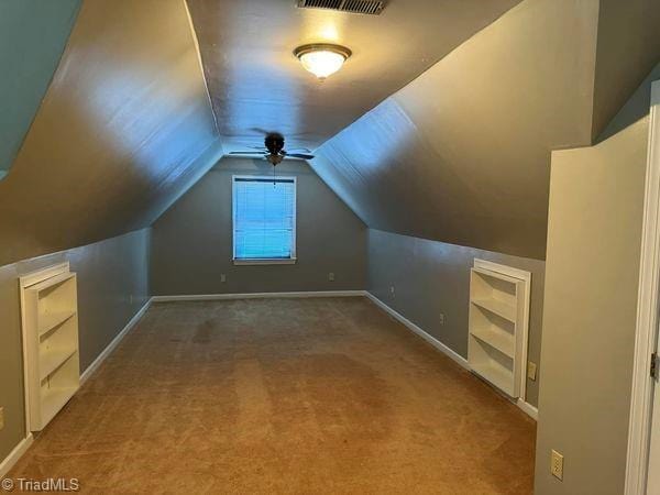 additional living space featuring visible vents, baseboards, carpet, and vaulted ceiling