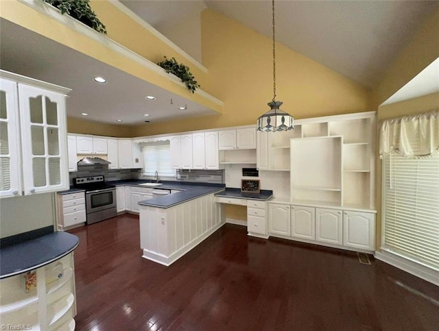 kitchen featuring decorative light fixtures, electric stove, white cabinets, and sink