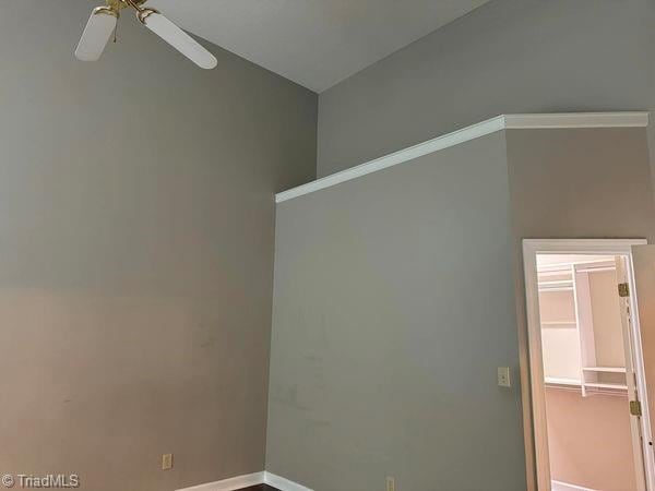 spare room with baseboards and ceiling fan