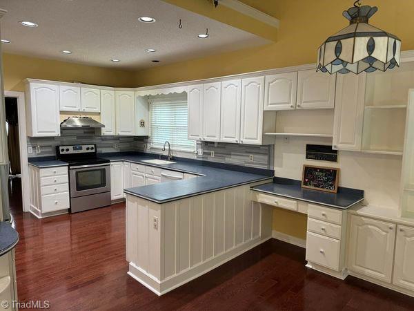 kitchen with a sink, stainless steel electric range oven, range hood, white cabinets, and open shelves