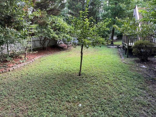 view of yard featuring a deck and fence