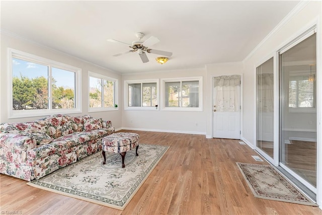 sunroom / solarium featuring a ceiling fan