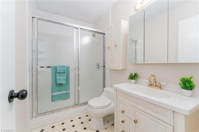 bathroom with tile patterned floors, a stall shower, toilet, and vanity