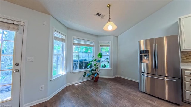 2309 Kasarda Dr, Greensboro, NC 27406 - unfurnished dining area with dark wood finished floors, lofted ceiling, and baseboards