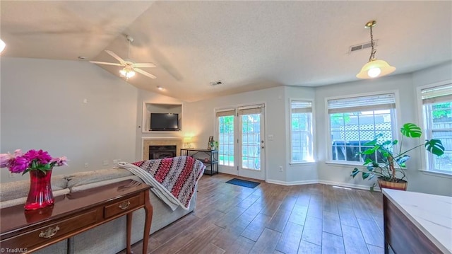 2309 Kasarda Dr, Greensboro, NC 27406 - living room with dark wood-style floors, healthy amount of natural light, a fireplace, a ceiling fan, and lofted ceiling