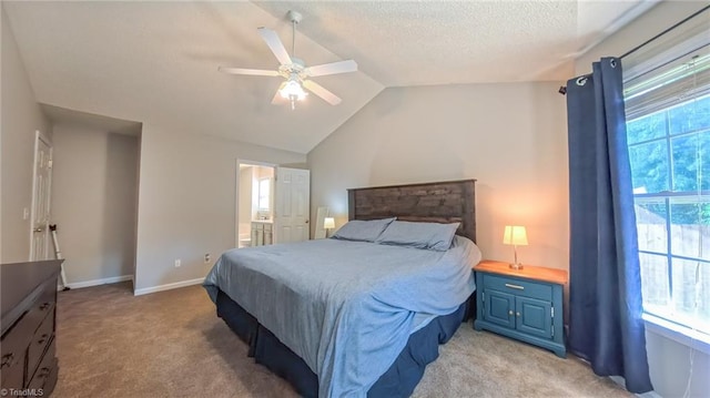 2309 Kasarda Dr, Greensboro, NC 27406 - bedroom with light carpet, vaulted ceiling, a ceiling fan, a textured ceiling, and baseboards