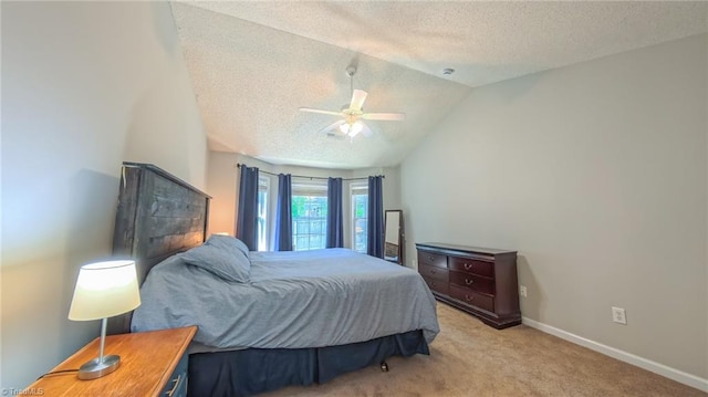 2309 Kasarda Dr, Greensboro, NC 27406 - bedroom featuring a textured ceiling, light colored carpet, lofted ceiling, baseboards, and a ceiling fan