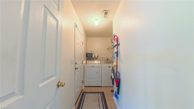 2309 Kasarda Dr, Greensboro, NC 27406 - doorway to outside with separate washer and dryer, a textured ceiling, and light tile patterned floors