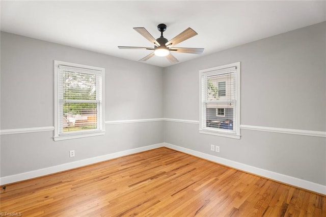 unfurnished room with healthy amount of natural light, light wood-style floors, baseboards, and a ceiling fan